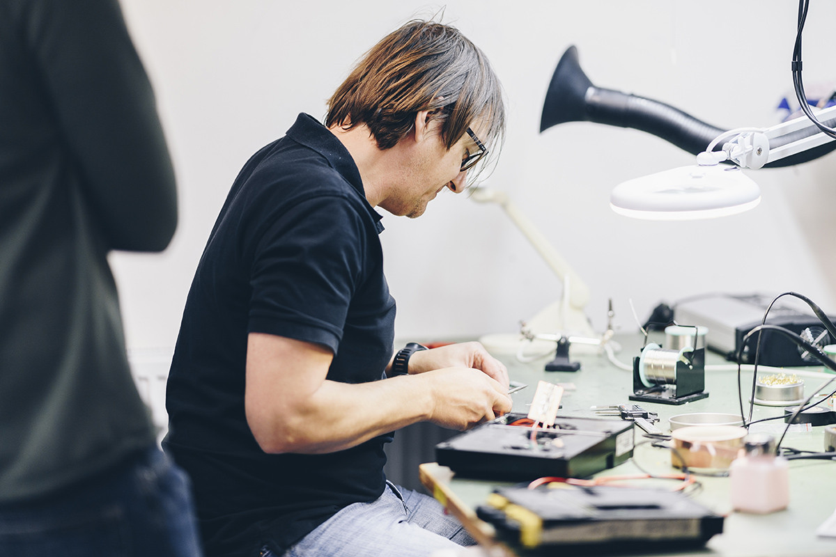 An engineer creating a custom electric charging platform for a customer.