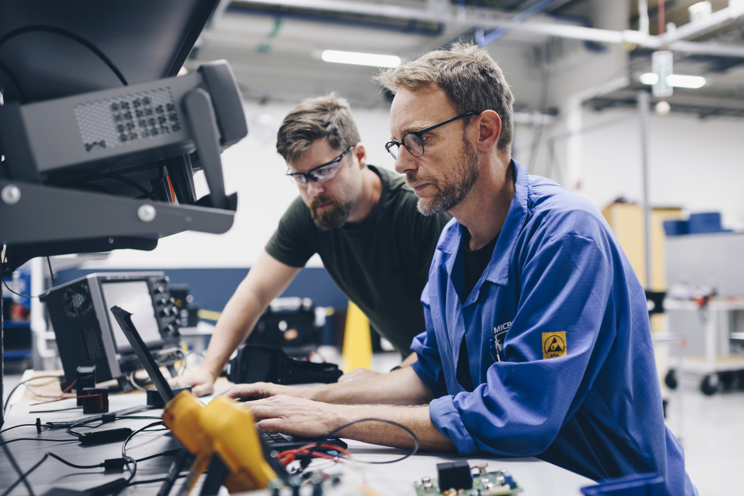 Two operators at monitors with software systems